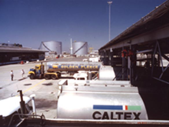 Caltex fuel tanks sitting in a lot in the middle of the day