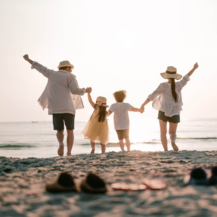 Family of four bonding at the beach on a sunny day