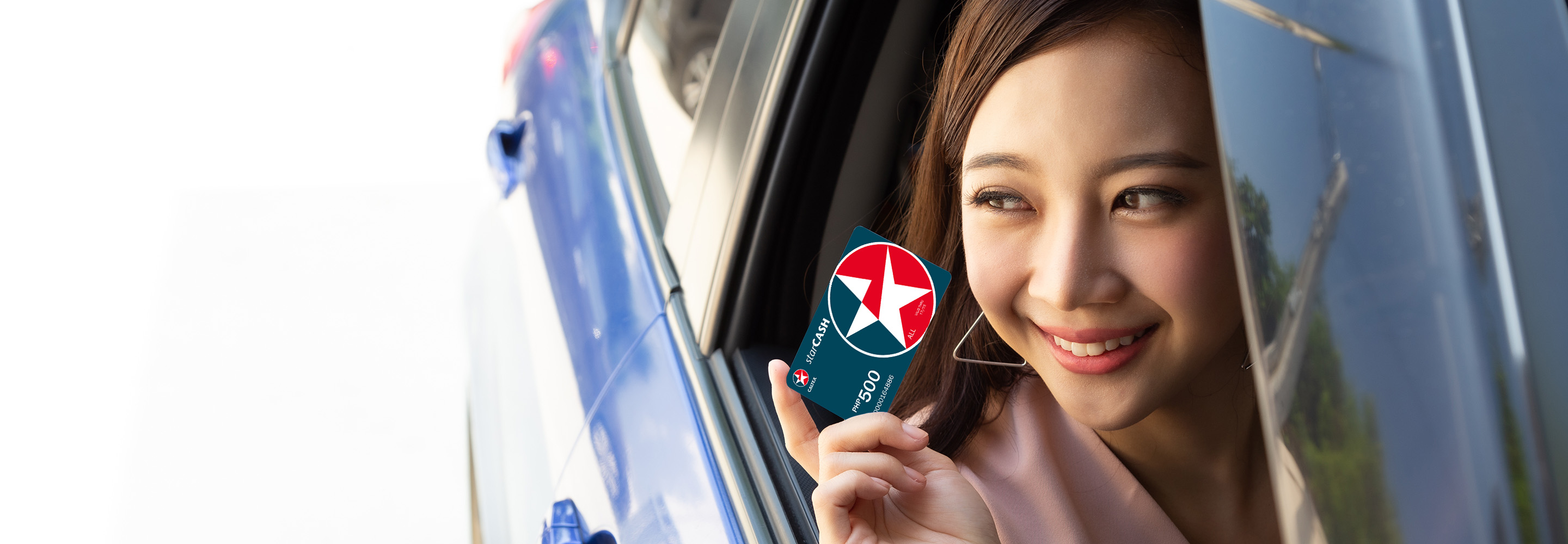 Woman holding Caltex StarCash card
