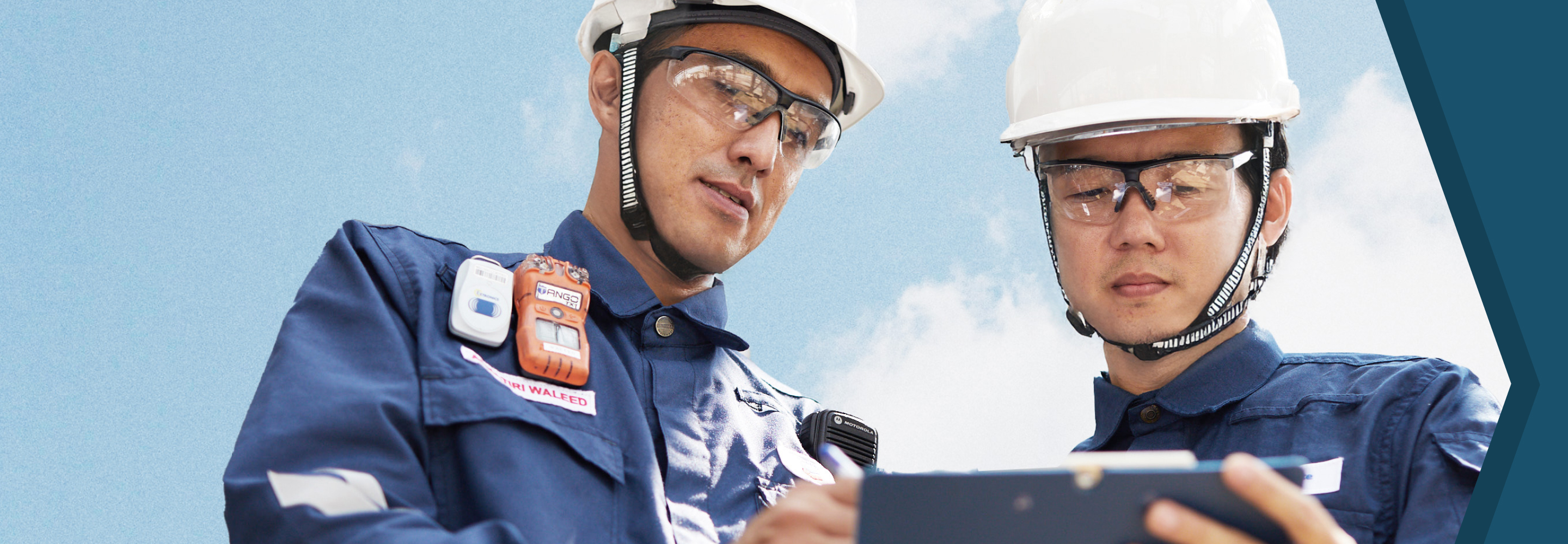 Two Caltex engineers looking at a clipboard