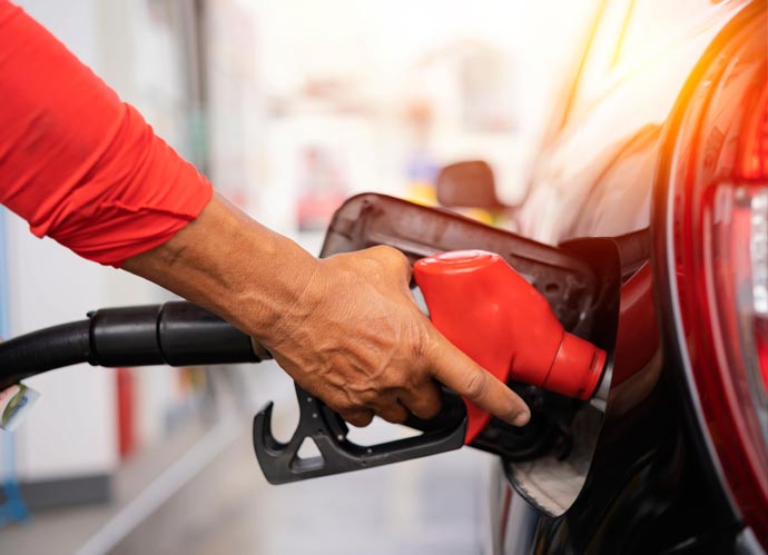 Close up of petrol nozzle fueling up a car