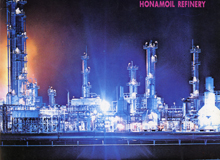 Brightly lit fuel factory stacks shining in the night