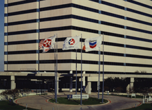 Texaco Caltex and Chevron flags flying in front of an office building