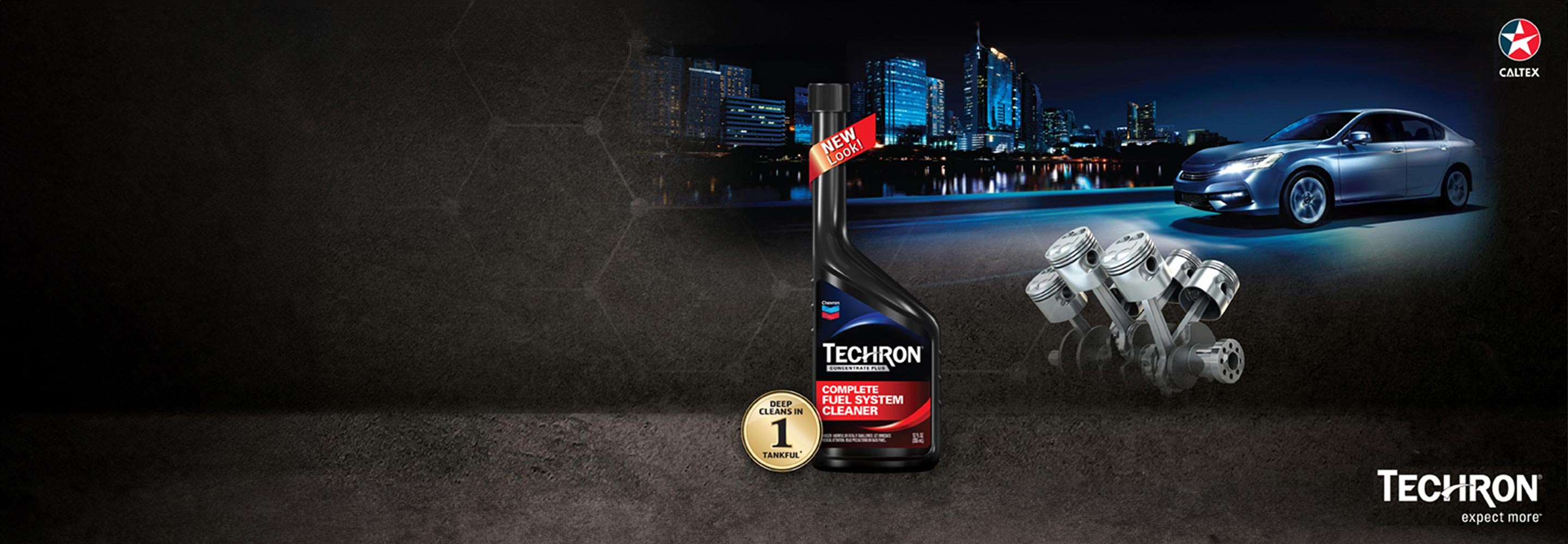 Bottle Techron® D Concentrate with engine pistons and a car driving against an evening cityscape