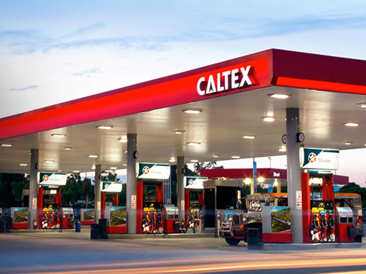 Brightly lit Caltex station with a jeep fuelling up