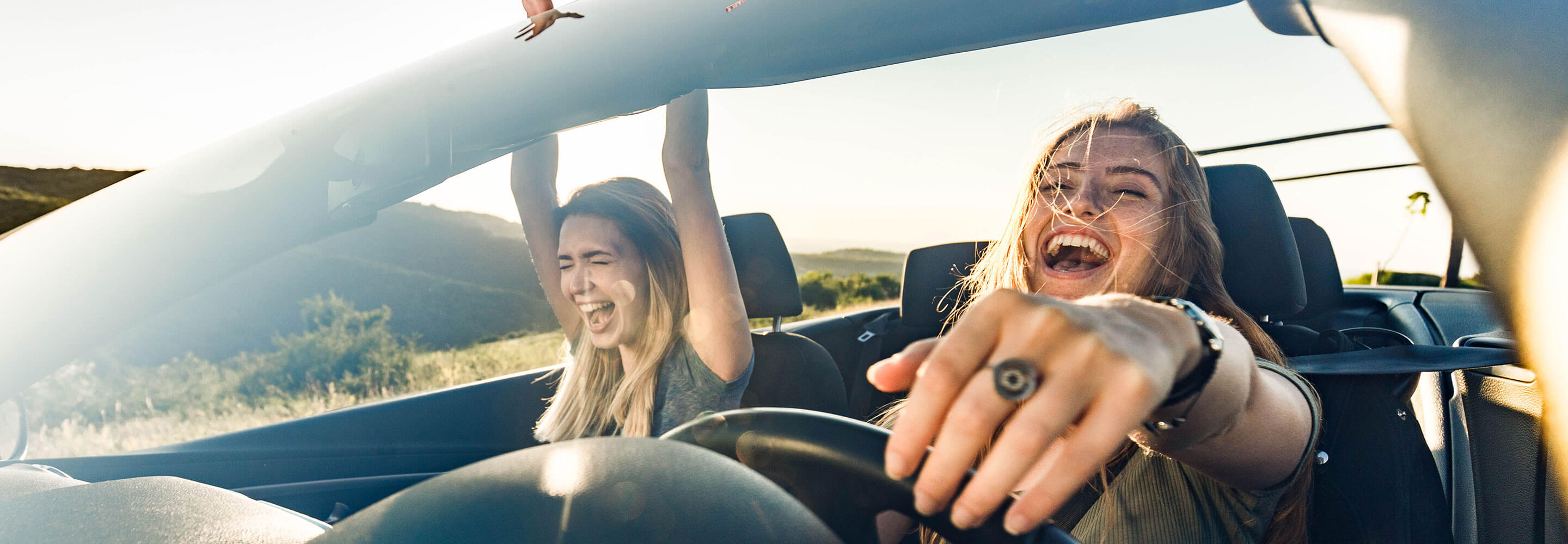 Two blond girls having fun on a roadtrip